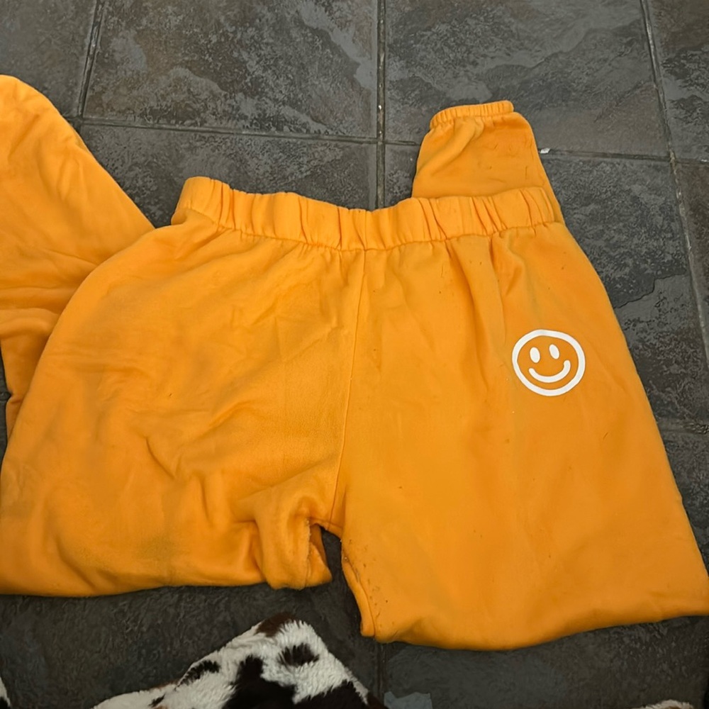 orange sweatpants with smiley face